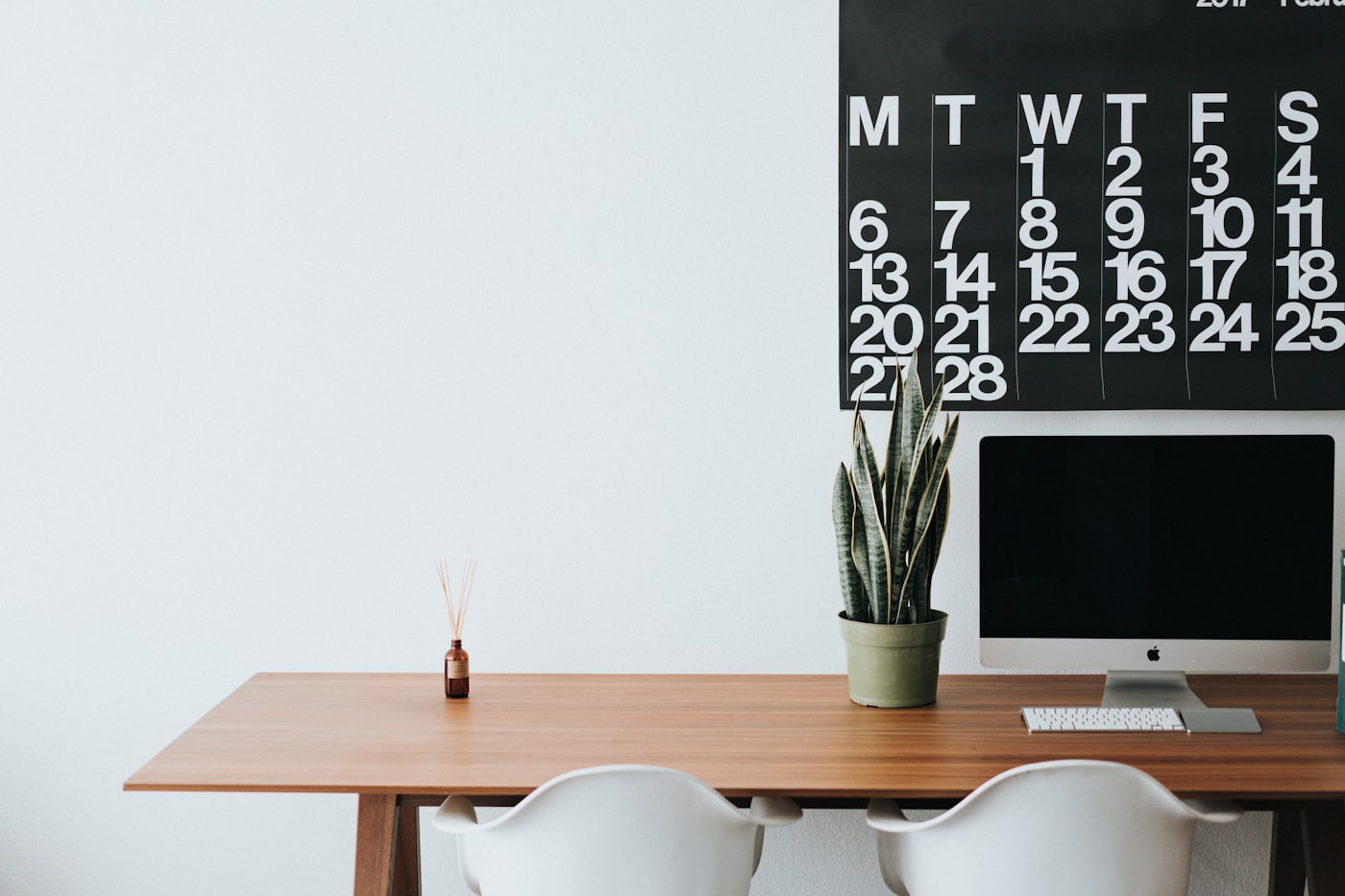 A tidy home office desk beside a window
